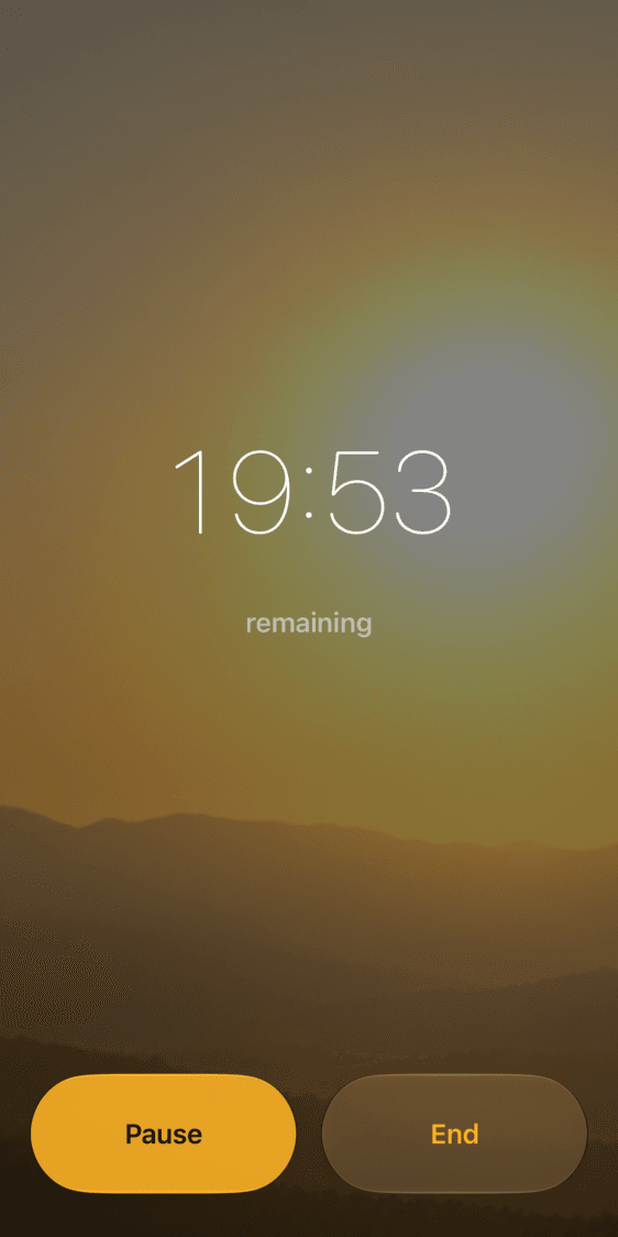 Meditation Bells timer showing 19:53 remaining over a golden sunset, with Pause and End buttons